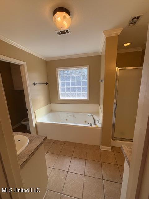 full bathroom with toilet, independent shower and bath, tile patterned floors, crown molding, and vanity