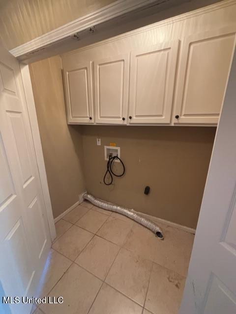 laundry room with cabinets, light tile patterned flooring, hookup for a washing machine, and electric dryer hookup