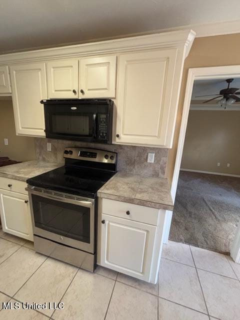 kitchen with stainless steel range with electric stovetop, ceiling fan, light tile patterned floors, and decorative backsplash