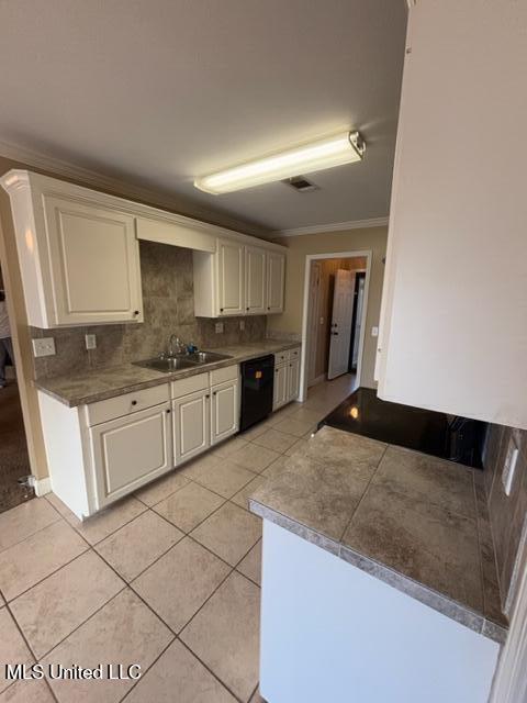 kitchen featuring dishwasher, sink, crown molding, light tile patterned flooring, and white cabinets