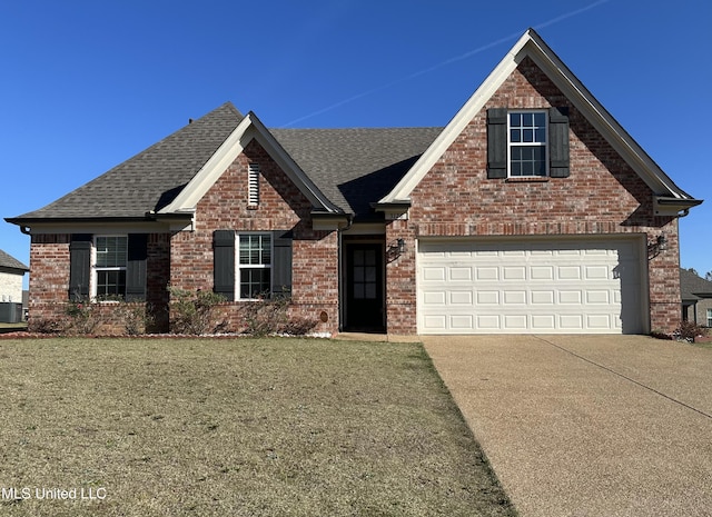 view of front of home with central AC, a front lawn, and a garage