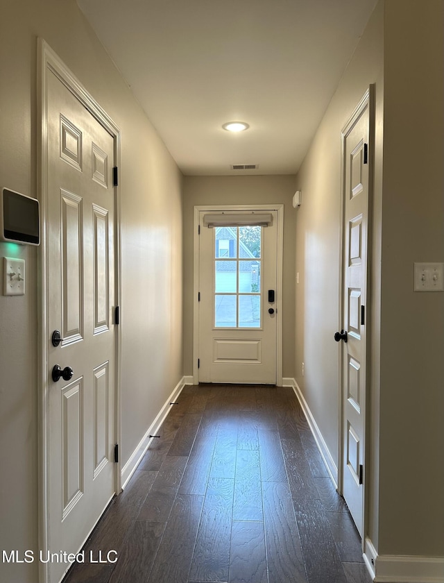 doorway featuring dark wood-type flooring