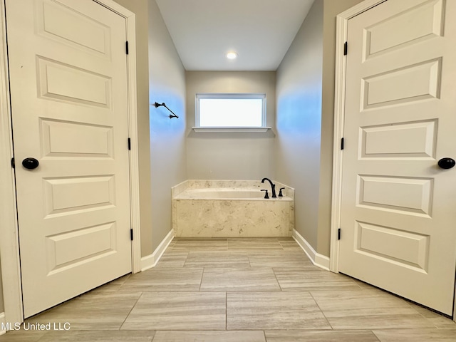 bathroom with tiled tub