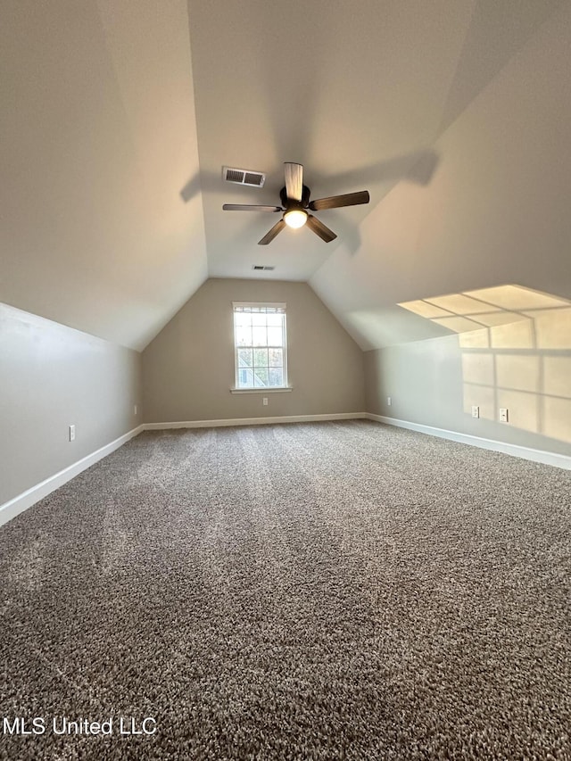 additional living space featuring carpet flooring, ceiling fan, and lofted ceiling