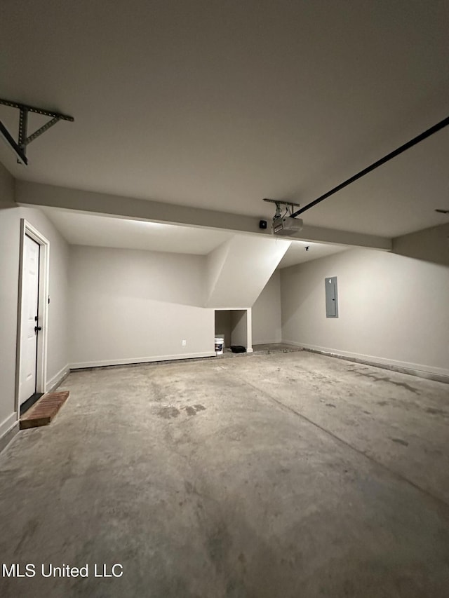 bonus room featuring electric panel and concrete floors