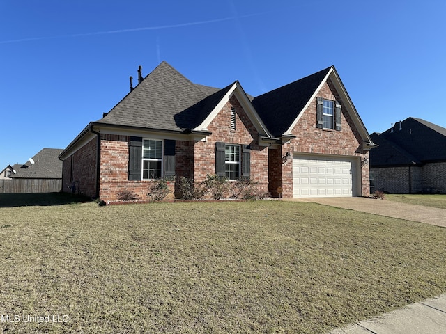 view of front of house featuring a garage and a front lawn