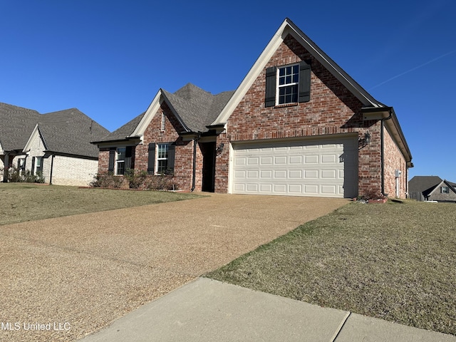 view of front of house with a garage and a front lawn