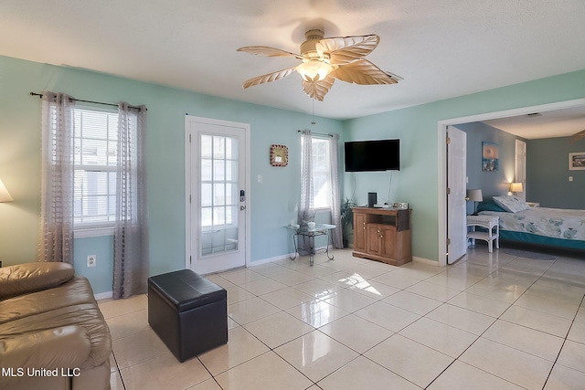 living room featuring light tile patterned floors and ceiling fan