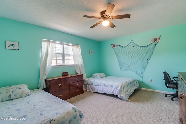 carpeted bedroom featuring ceiling fan and a textured ceiling