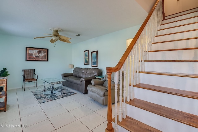 tiled living room with ceiling fan