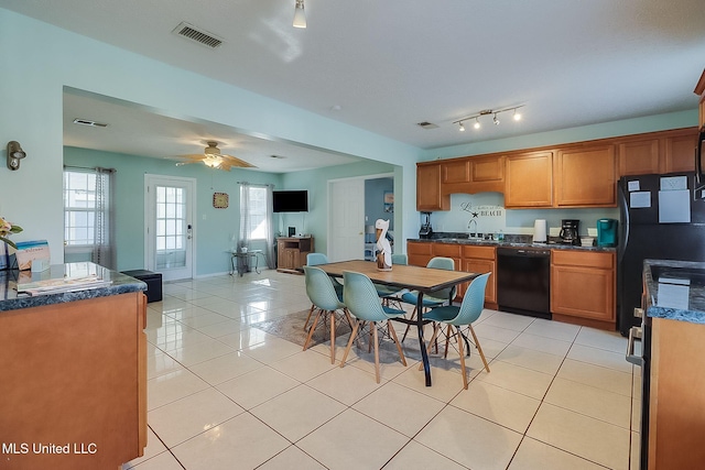 kitchen featuring light tile patterned floors, black appliances, sink, and ceiling fan