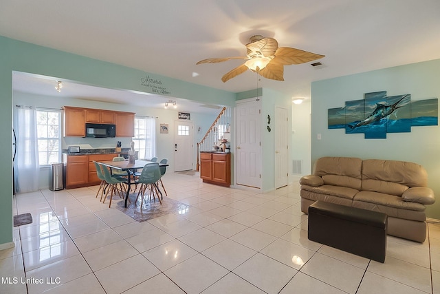 tiled living room featuring ceiling fan