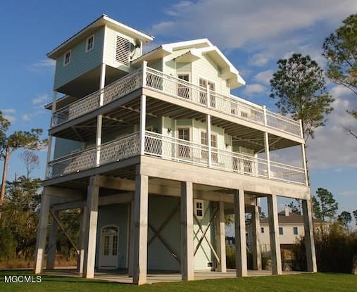 back of property featuring a yard and a balcony