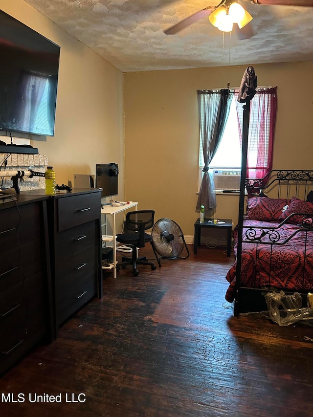 bedroom featuring dark hardwood / wood-style floors, a textured ceiling, and ceiling fan