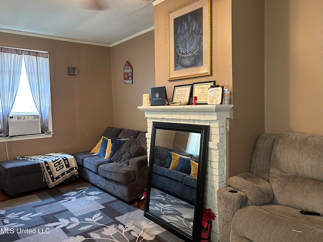 living room featuring cooling unit, ornamental molding, hardwood / wood-style floors, and a fireplace