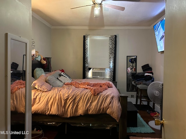 bedroom with crown molding, cooling unit, and ceiling fan