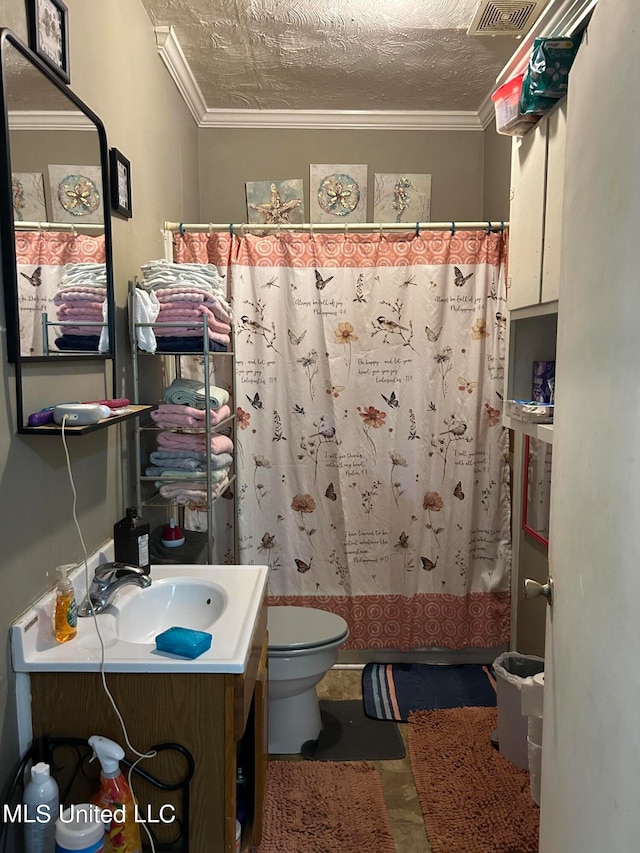 bathroom featuring a textured ceiling, toilet, walk in shower, vanity, and crown molding