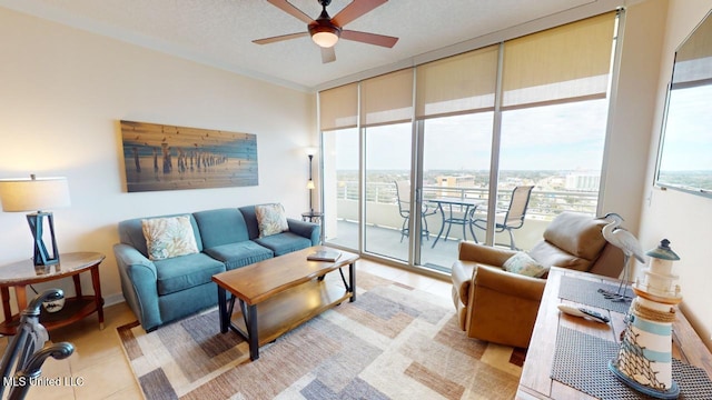 living room with a textured ceiling, ceiling fan, and a wall of windows