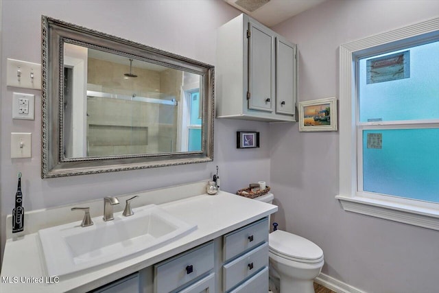 full bath with walk in shower, vanity, and toilet