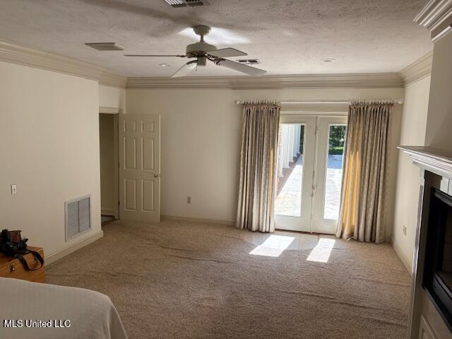 interior space with french doors, visible vents, ornamental molding, access to outside, and carpet