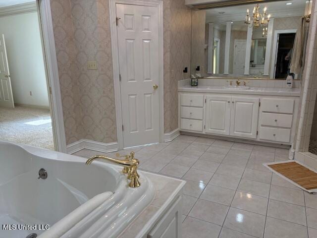 full bathroom featuring a washtub, vanity, tile patterned floors, a chandelier, and wallpapered walls
