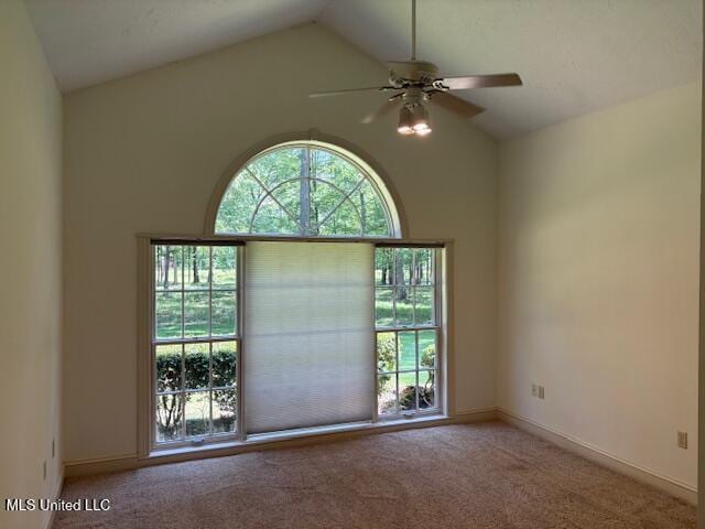 unfurnished room with baseboards, carpet, ceiling fan, and high vaulted ceiling