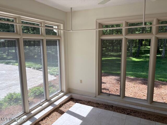 unfurnished dining area featuring tile patterned floors and baseboards