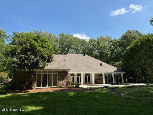 back of property with a yard