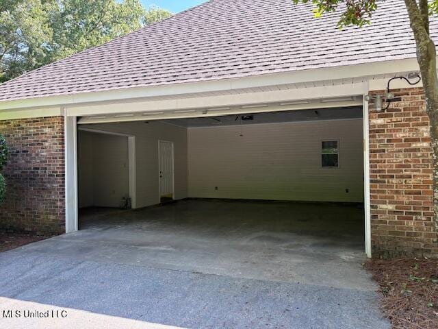 garage featuring concrete driveway