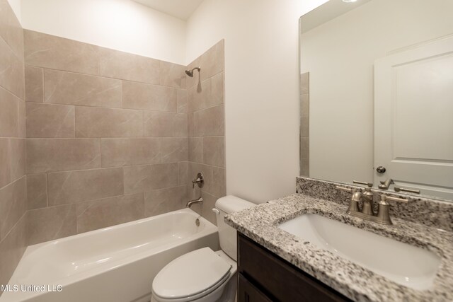 full bathroom featuring vanity, tiled shower / bath combo, and toilet