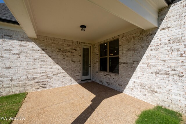 entrance to property with a patio area