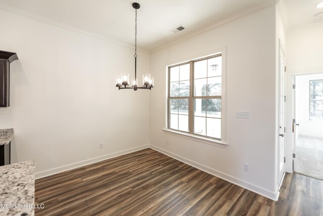 unfurnished dining area featuring ornamental molding, a notable chandelier, and dark hardwood / wood-style floors