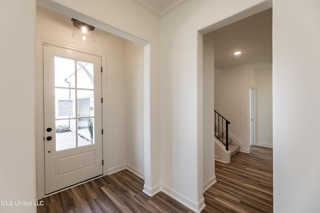 doorway with crown molding and dark hardwood / wood-style flooring