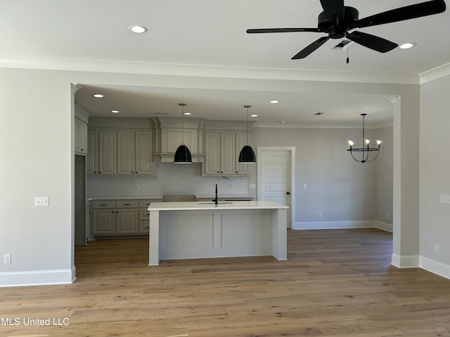 kitchen with baseboards, light wood finished floors, light countertops, crown molding, and backsplash