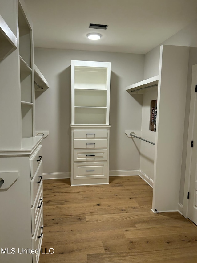 walk in closet with visible vents and light wood-type flooring