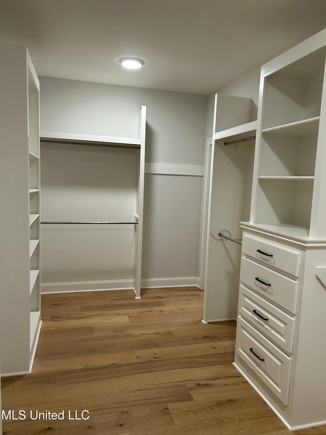 spacious closet with wood finished floors