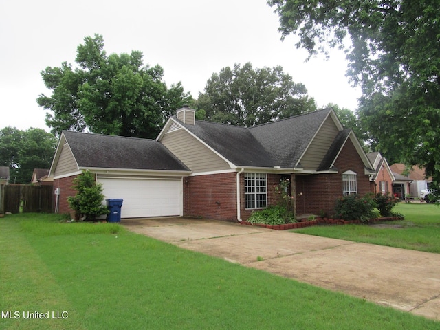 6933 Fox Briar Cv, Walls, MS 38680 - view of front facade with brick siding, driveway, a front lawn, and a chimney