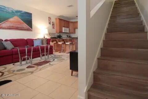 staircase featuring tile patterned flooring