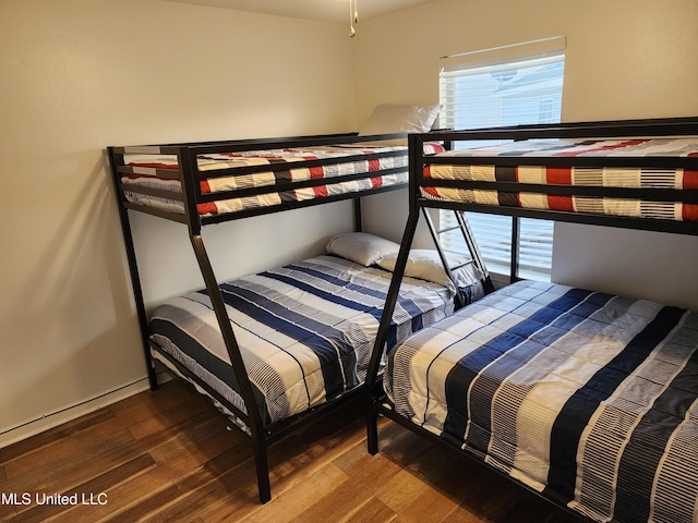 bedroom with dark wood-type flooring