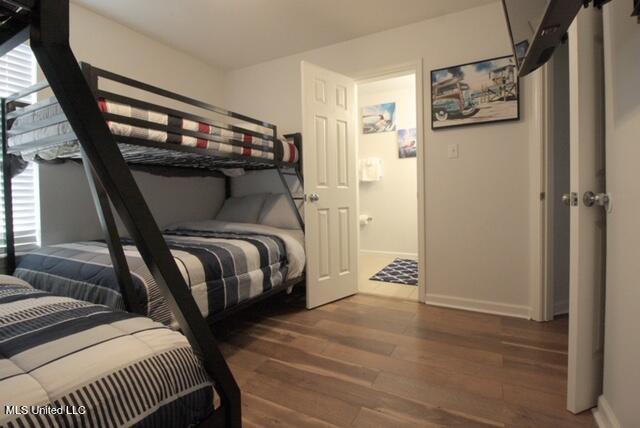 bedroom with dark wood-type flooring