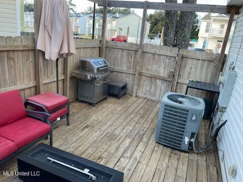 wooden terrace featuring grilling area and central AC unit