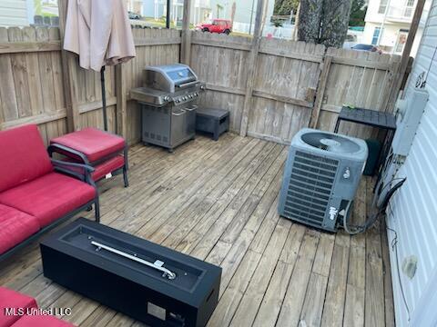 deck featuring an outdoor hangout area, area for grilling, and cooling unit