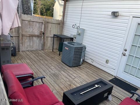 wooden terrace featuring cooling unit and an outdoor hangout area