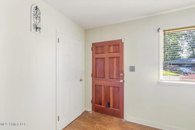 foyer entrance with light hardwood / wood-style floors