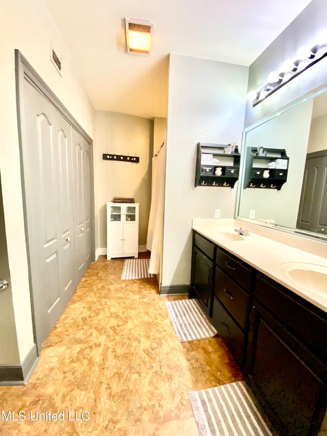 bathroom with vanity and a textured ceiling