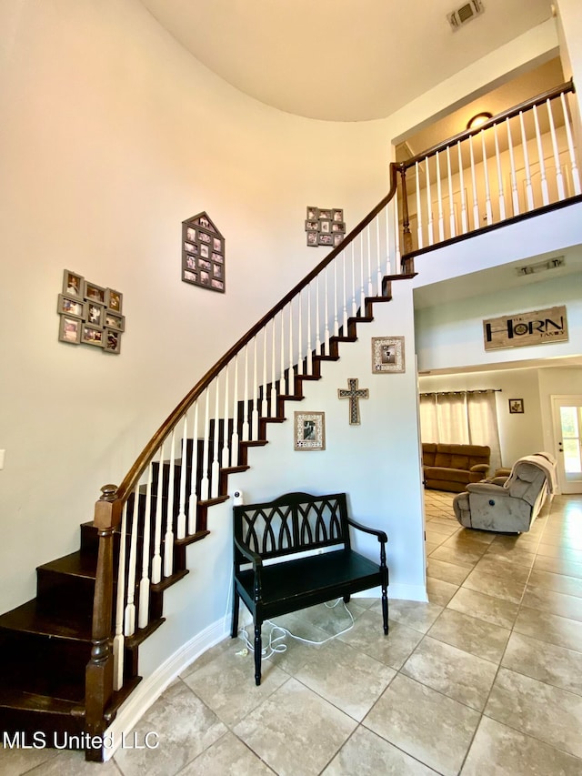 staircase with a high ceiling