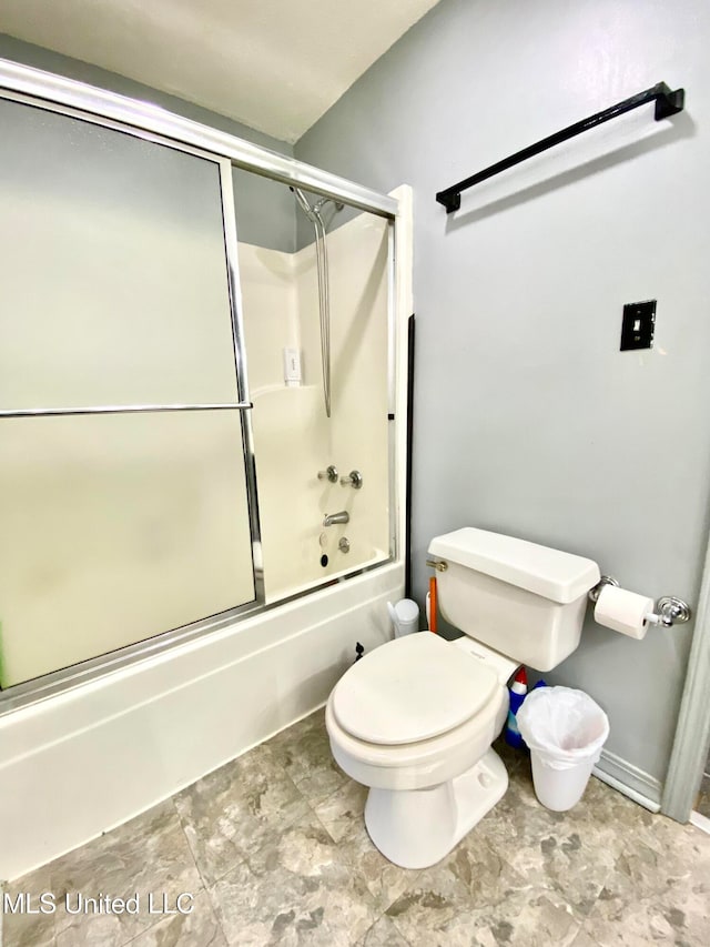 bathroom with enclosed tub / shower combo and toilet