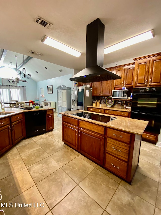 kitchen featuring lofted ceiling, stainless steel appliances, island range hood, and light tile patterned floors