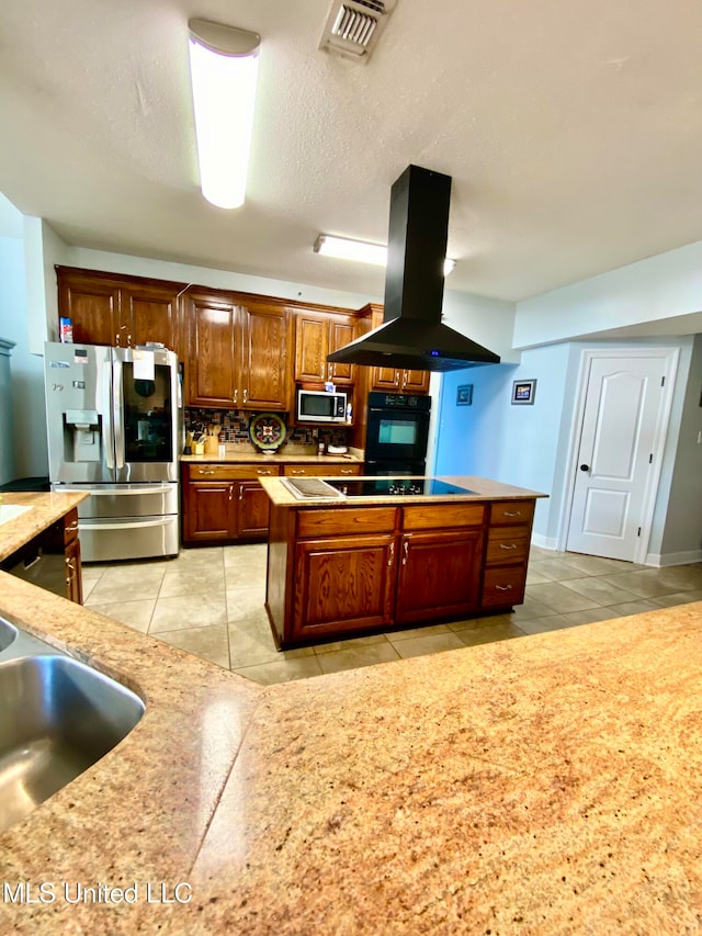 kitchen with tasteful backsplash, black appliances, sink, island exhaust hood, and light tile patterned floors