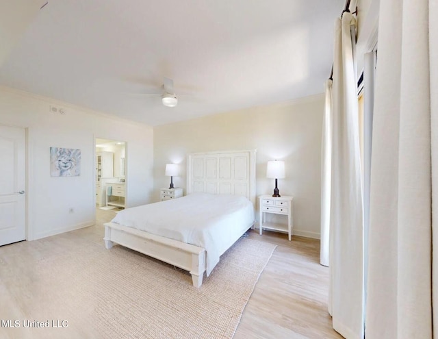 bedroom featuring connected bathroom, a closet, ornamental molding, light hardwood / wood-style floors, and ceiling fan